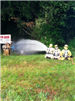3 firefighters shooting water from hose