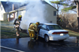 firefighter looking into smoking car