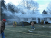 firefighters in front of smoking house