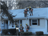 firefighters placing ladder on house