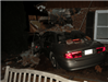grey car crashed into brick house