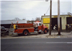 Red Fire Truck in Front of Muffler Business 