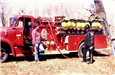 Two People Standing in Front of Red Fire Truck