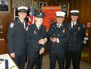 4 men in navy blue uniforms