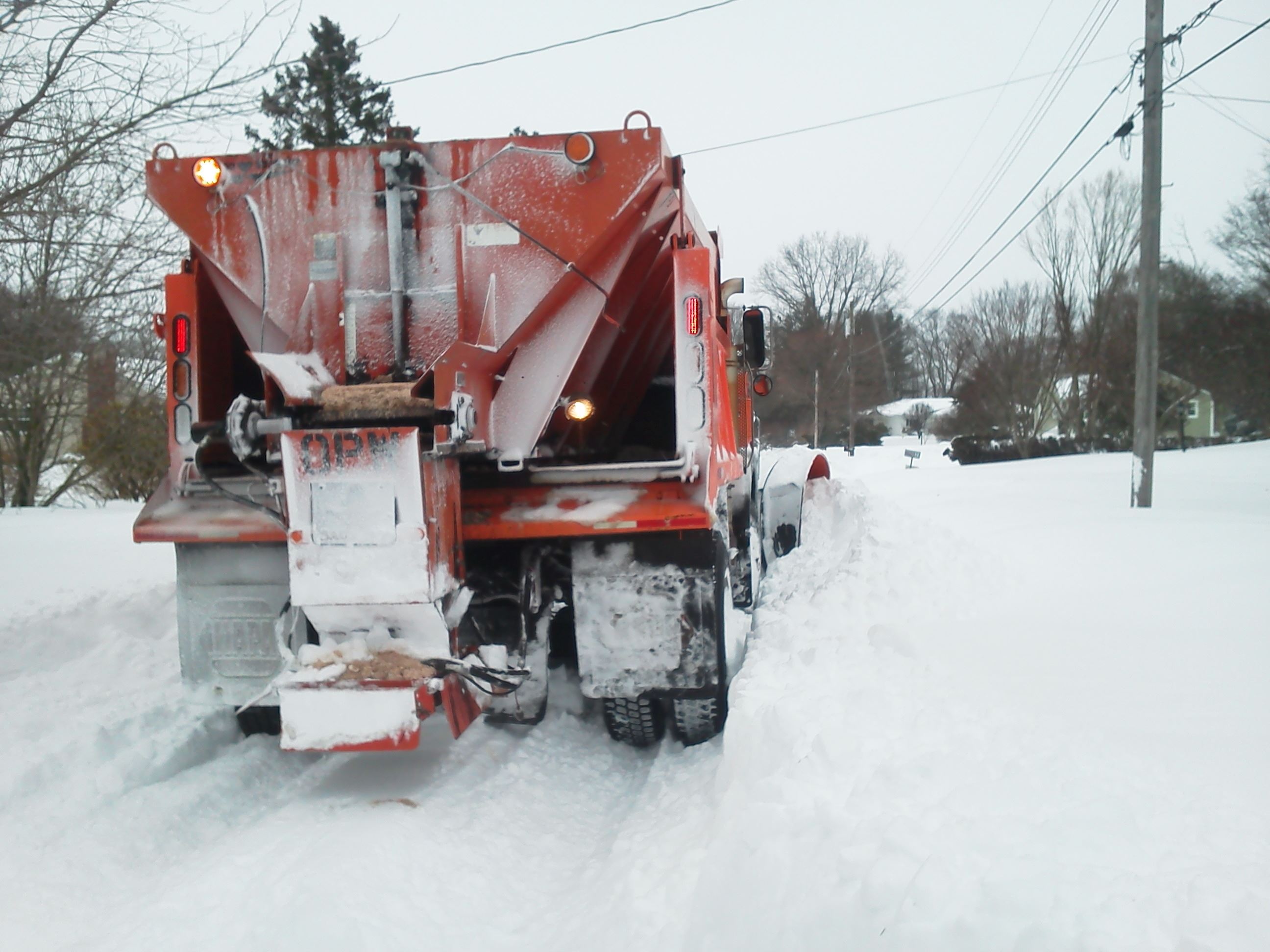 Back of Orange plow truck in snow