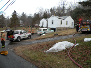 cars on road with snow on grass