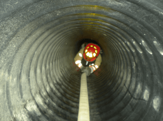 firefighter going through a grey tunnel