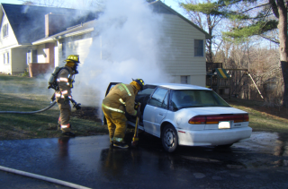 firefighter looking into smoking car