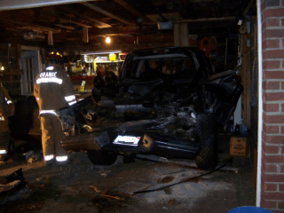 firefighters around damaged car