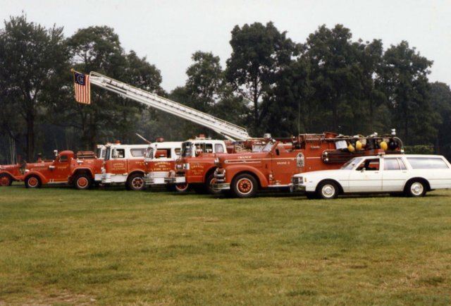 Red Fire Trucks and a White Car 