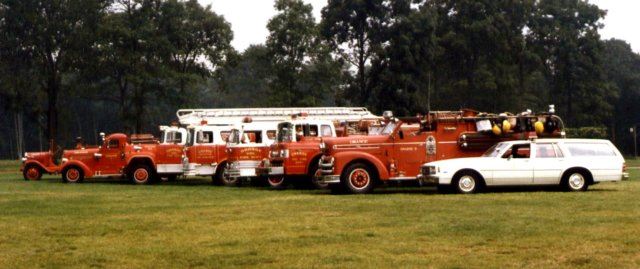 Red Fire Trucks and a White Car