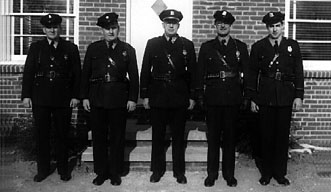 5 police officers standing together.
